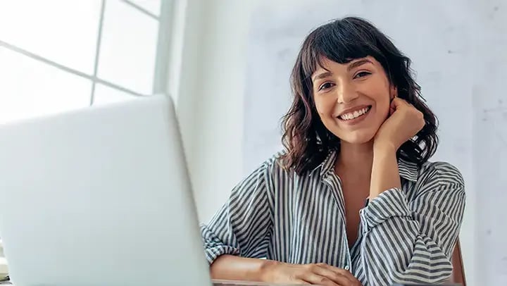 Portrayal of a Capella student using a laptop to earn a competency-based education.